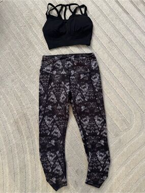 CALIA Black Sports Bra and Black and Gray abstract print capri length leggings.